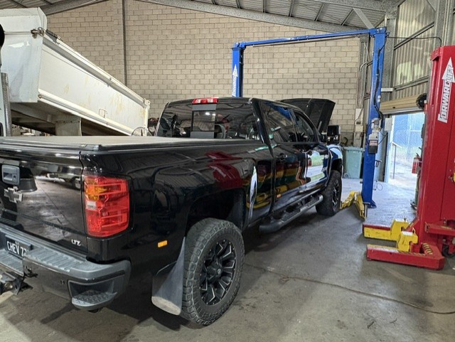 Black Chevrolet Silverado ute in the workshop bay ready for a 4x4 touring and towing service